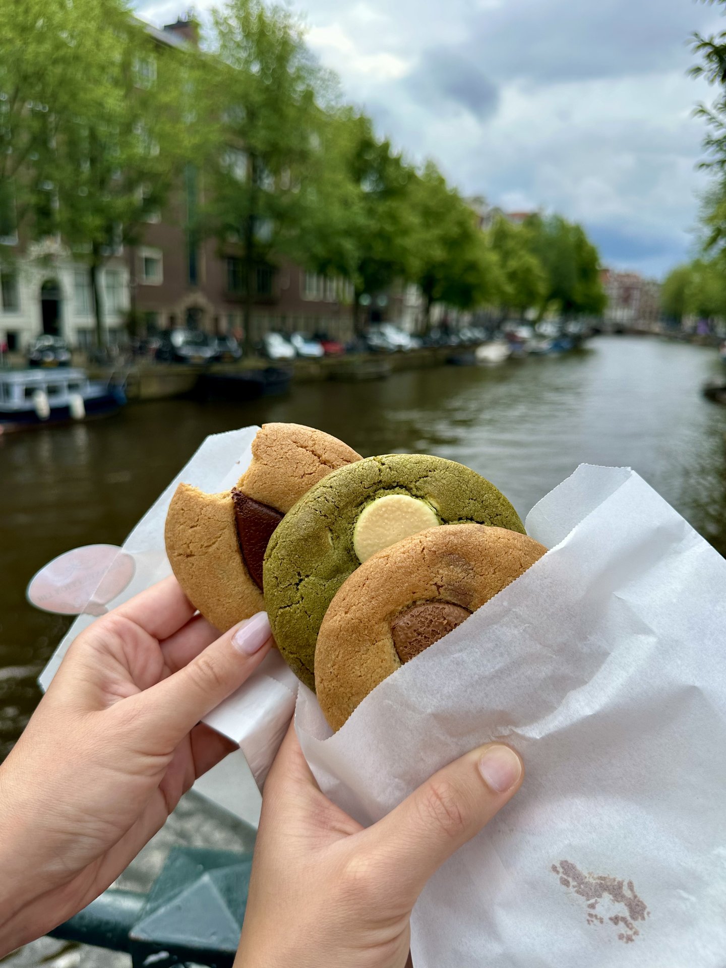Cookies held over an Amsterdam canal on a summer day