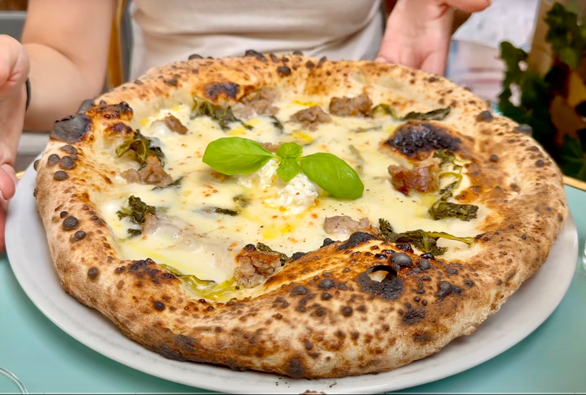 A beautifully charred sourdough pizza at Pizzeria Dope in Amsterdam
