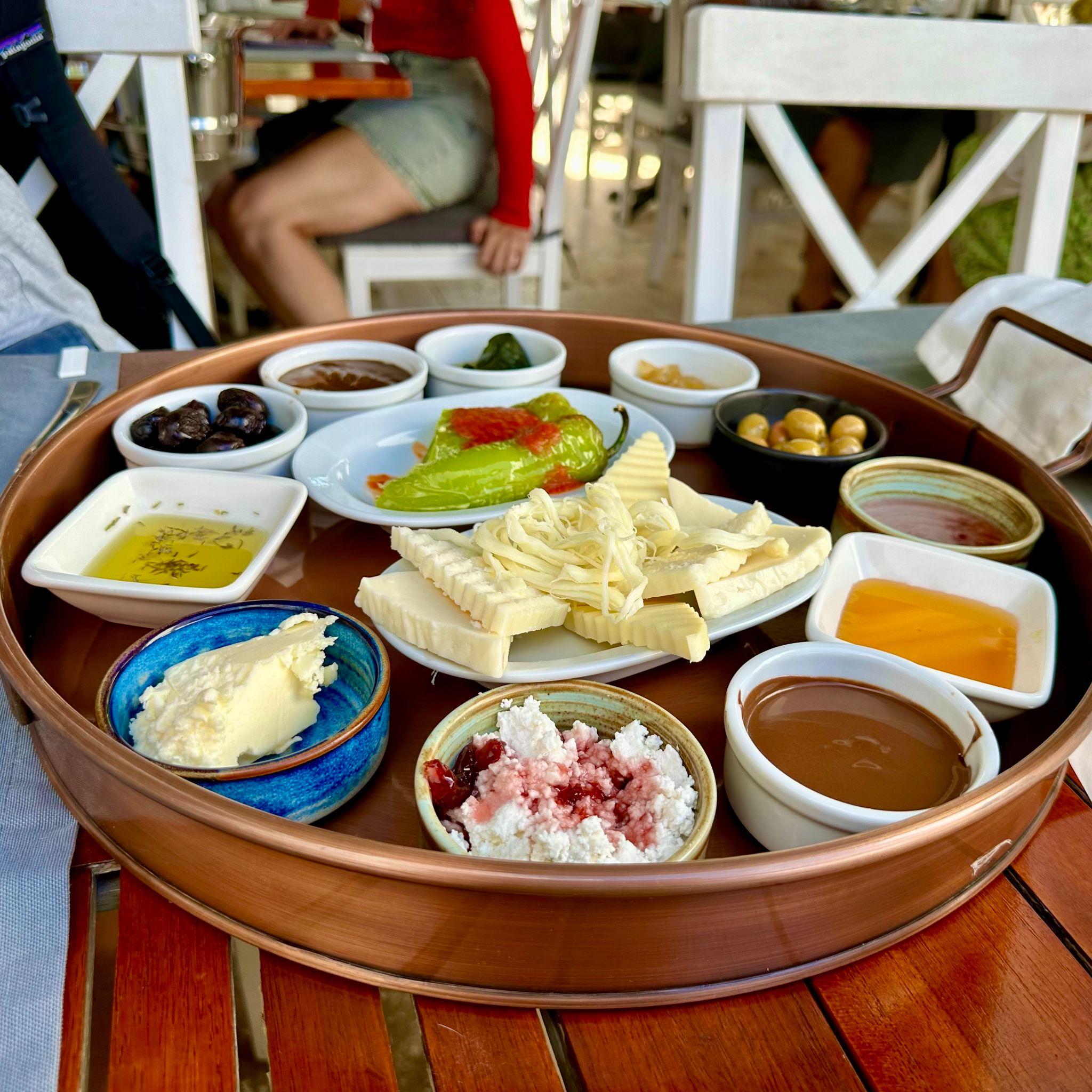 Turkish breakfast spread with local cheeses, olives, jams and bread, Bozcaada, Turkey