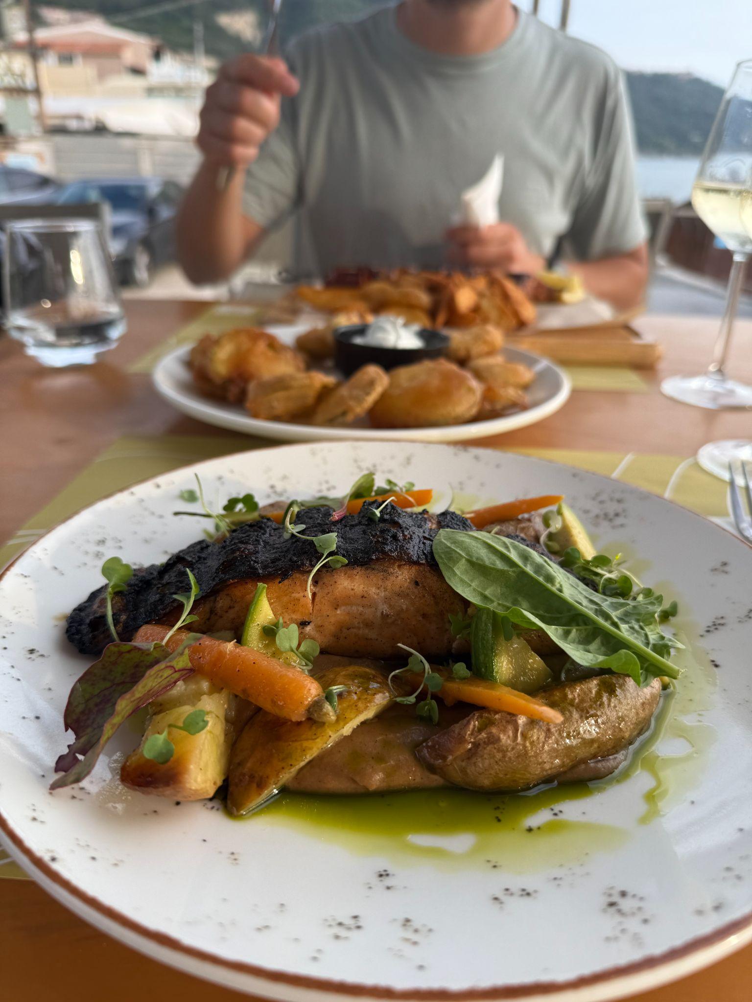 Blackened salmon with roasted vegetables and potatoes at Skal restaurant in Agios Gordios, Corfu