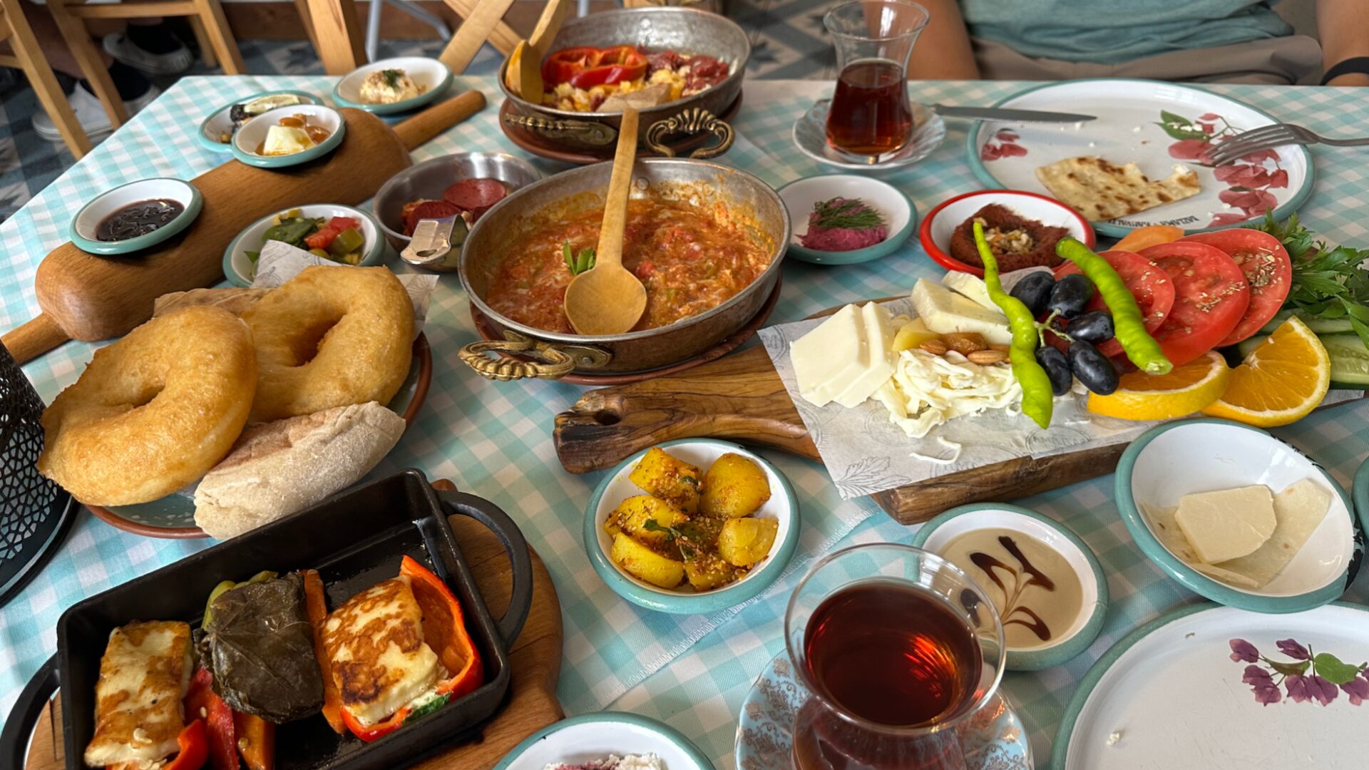 A traditional Turkish breakfast spread with cheeses, olives, bread, jams, eggs and glasses of çay in Istanbul