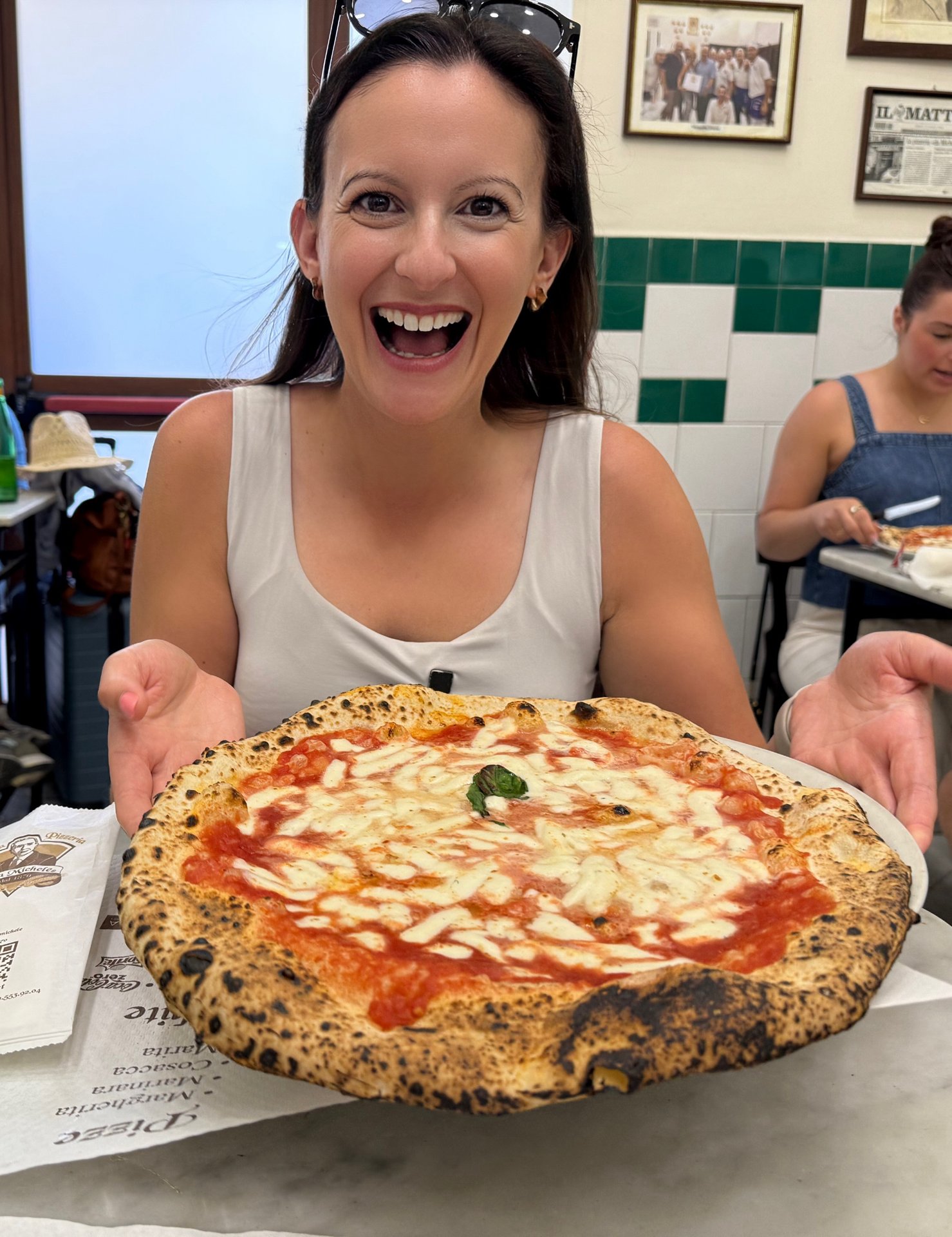 Alex holding a freshly made margherita pizza at L'Antica Pizzeria Da Michele in Naples