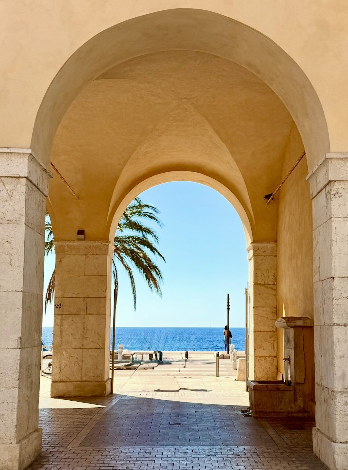 The pebble beach and turquoise water along the Promenade des Anglais in Nice