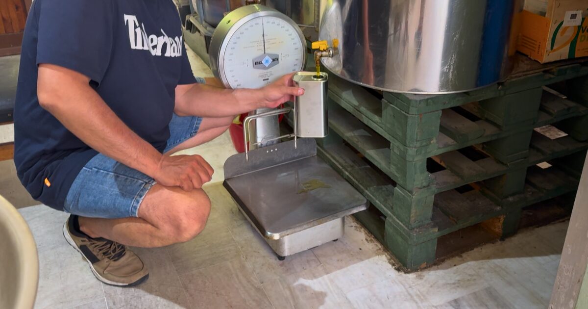 Fresh olive oil being poured at a small shop in Kalamata, Greece