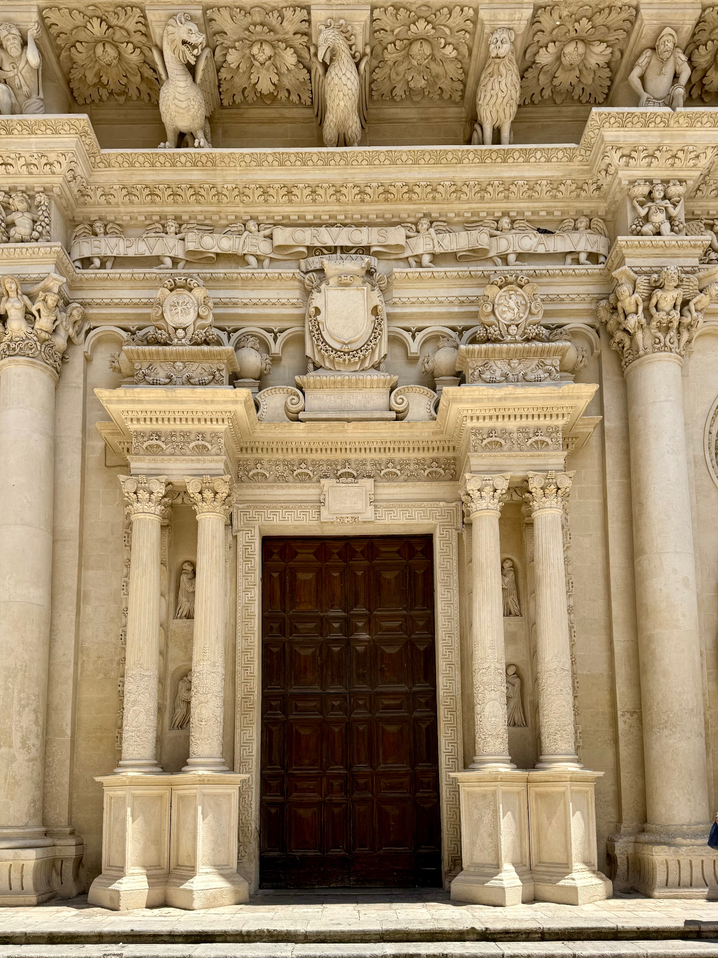 Ornate baroque facade of the Basilica di Santa Croce in Lecce with carved stone columns and sculptures