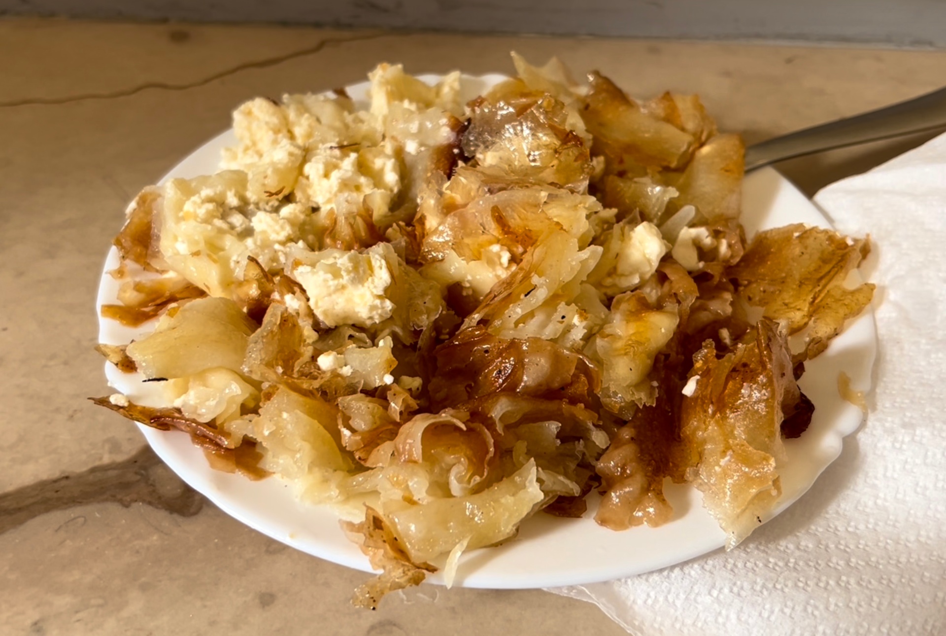 Plate of flaky burek pastry topped with cheese from Dolac Market in Zagreb